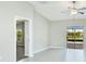 Bright living room with tile flooring, ceiling fan, and sliding glass doors with access to the outdoor patio at 5327 Olano St, Palmetto, FL 34221