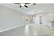 Open living space featuring tile flooring, neutral walls, modern light fixtures, and natural light from a window at 5327 Olano St, Palmetto, FL 34221