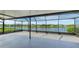 The screened lanai features an outdoor ceiling fan and a view of the tranquil pond at 5327 Olano St, Palmetto, FL 34221