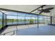A spacious screened patio offers shade and features an outdoor ceiling fan and a view of the pond at 5327 Olano St, Palmetto, FL 34221