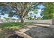 A spacious backyard features a huge tree for shade and is surrounded by a white privacy fence at 5718 Magnolia N St, St Petersburg, FL 33703