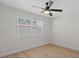 Minimalist bedroom with natural light, sleek flooring, and a ceiling fan at 5718 Magnolia N St, St Petersburg, FL 33703