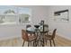 Bright dining area featuring a modern glass table and stylish decor, illuminated by natural light at 5718 Magnolia N St, St Petersburg, FL 33703