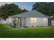Charming single-story home with a freshly painted exterior and well-manicured lawn at twilight at 5718 Magnolia N St, St Petersburg, FL 33703