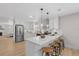 Modern kitchen boasts white cabinets, stainless steel appliances, and a breakfast bar at 5718 Magnolia N St, St Petersburg, FL 33703
