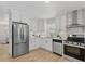 Bright kitchen with stainless steel appliances, white cabinets, and ample counter space at 5718 Magnolia N St, St Petersburg, FL 33703