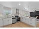 Well-lit kitchen with white cabinets, stainless steel appliances, and an island with seating at 5718 Magnolia N St, St Petersburg, FL 33703