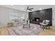 Bright living room showcases a stone fireplace, hardwood floors, and comfortable seating at 5718 Magnolia N St, St Petersburg, FL 33703
