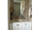 Bathroom featuring a vanity with white cabinets, a neutral toned countertop, and tiled wall at 675 El Centro # 675, Longboat Key, FL 34228