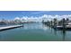 Picturesque view of a serene harbor with multiple boats docked under a sunny sky at 675 El Centro # 675, Longboat Key, FL 34228