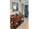 Inviting entryway featuring wood console table with decor and mirror, complemented by tile floors at 675 El Centro # 675, Longboat Key, FL 34228