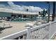Community pool with lounge chairs and umbrellas for relaxing by the poolside at 675 El Centro # 675, Longboat Key, FL 34228