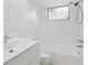 Bright bathroom with white tile, shower and tub combo, modern vanity, and window for natural light at 6961 Alken Cir, New Port Richey, FL 34653