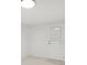 The all-white bedroom has a glass back door at 6961 Alken Cir, New Port Richey, FL 34653