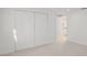 Bedroom featuring plush carpeting, neutral walls, and a spacious closet with sliding doors at 6961 Alken Cir, New Port Richey, FL 34653