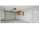 Spacious garage featuring epoxy flooring, overhead storage, and a secure garage door at 6961 Alken Cir, New Port Richey, FL 34653