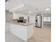 Modern kitchen featuring stainless steel appliances, granite countertops, and a breakfast bar at 6961 Alken Cir, New Port Richey, FL 34653