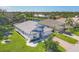Scenic aerial view of a home overlooking a tranquil pond and lush greenery at 7005 Goldrush Ln, Bradenton, FL 34201