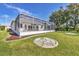 A lovely home backyard with a screen enclosed patio, beautiful lawn, and decorative stone features at 7005 Goldrush Ln, Bradenton, FL 34201