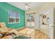 This bedroom features a sliding glass door entrance, wood-look floors, and large window at 7005 Goldrush Ln, Bradenton, FL 34201