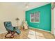 This bedroom features a nice window view, wood-look floors, and 2 comfortable chairs at 7005 Goldrush Ln, Bradenton, FL 34201