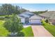 Charming single-story home featuring a well-manicured lawn, brick driveway, and attached two car garage at 7005 Goldrush Ln, Bradenton, FL 34201