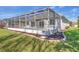 Exterior view shows the spacious lanai, lush lawn, and well-maintained landscaping at 7005 Goldrush Ln, Bradenton, FL 34201