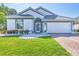 Charming single-story home featuring a beautifully manicured lawn and a two-car garage at 7005 Goldrush Ln, Bradenton, FL 34201