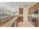 Modern kitchen with stainless steel appliances, granite countertops, and ample storage at 7005 Goldrush Ln, Bradenton, FL 34201