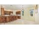 Bright kitchen and dining area with tile floors, modern lighting, and breakfast bar seating at 7005 Goldrush Ln, Bradenton, FL 34201