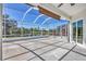 This screened lanai features ample space for outdoor entertaining with serene water views at 7005 Goldrush Ln, Bradenton, FL 34201