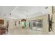 Spacious living area featuring tile floors, neutral paint, and large sliding doors at 7005 Goldrush Ln, Bradenton, FL 34201
