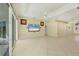 Open-concept living area with tile flooring, ceiling fan, and access to the patio at 7005 Goldrush Ln, Bradenton, FL 34201
