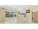 Bright living room with sliding glass doors, tile flooring and a ceiling fan at 7005 Goldrush Ln, Bradenton, FL 34201