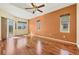 Spacious primary bedroom with hardwood floors, a tray ceiling, and large windows at 7005 Goldrush Ln, Bradenton, FL 34201