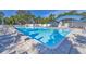 Beautiful community pool with clear blue water, poolside seating, and lush landscaping creating a relaxing atmosphere at 7005 Goldrush Ln, Bradenton, FL 34201