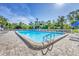 Bright, sunny outdoor pool area with clear, inviting water and convenient ladder access for residents to enjoy at 7005 Goldrush Ln, Bradenton, FL 34201