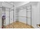 Walk-in closet with metal shelving and laminate floors, for optimal storage and organization at 7005 Goldrush Ln, Bradenton, FL 34201