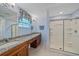 This bathroom includes granite countertops, double sinks, and a glass-enclosed shower at 8755 Dolomite Ave, North Port, FL 34287