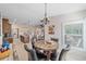 Breakfast nook with a marble-top table, four chairs, and natural light coming through a window at 8755 Dolomite Ave, North Port, FL 34287