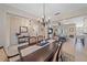 Open-concept dining area with elegant table, chairs, and view to the living room at 8755 Dolomite Ave, North Port, FL 34287