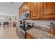 This traditional kitchen features granite countertops, tile backsplash, and stainless steel appliances at 8755 Dolomite Ave, North Port, FL 34287