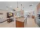 Open-concept kitchen with granite countertops, stainless steel appliances, and a breakfast bar at 8755 Dolomite Ave, North Port, FL 34287