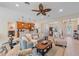 Open-concept living room with modern decor, ceiling fan, and access to the kitchen at 8755 Dolomite Ave, North Port, FL 34287