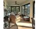 The cozy sunroom features wicker furniture and lots of natural light at 8755 Dolomite Ave, North Port, FL 34287
