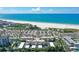 An aerial shot showcasing the condo complex and beach with ocean views and a well-manicured landscape at 925 Beach Rd # 408, Sarasota, FL 34242