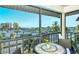 Enjoy the partial ocean view from this relaxing balcony with a table and chairs at 925 Beach Rd # 408, Sarasota, FL 34242