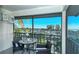 Relaxing balcony with seating and stunning views of the beach, palm trees and landscape at 925 Beach Rd # 408, Sarasota, FL 34242