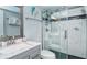 Bathroom featuring a marble vanity, toilet and walk in glass shower with dark tile flooring at 925 Beach Rd # 408, Sarasota, FL 34242