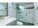 Bathroom featuring a marble vanity, toilet and walk in glass shower with dark tile flooring at 925 Beach Rd # 408, Sarasota, FL 34242